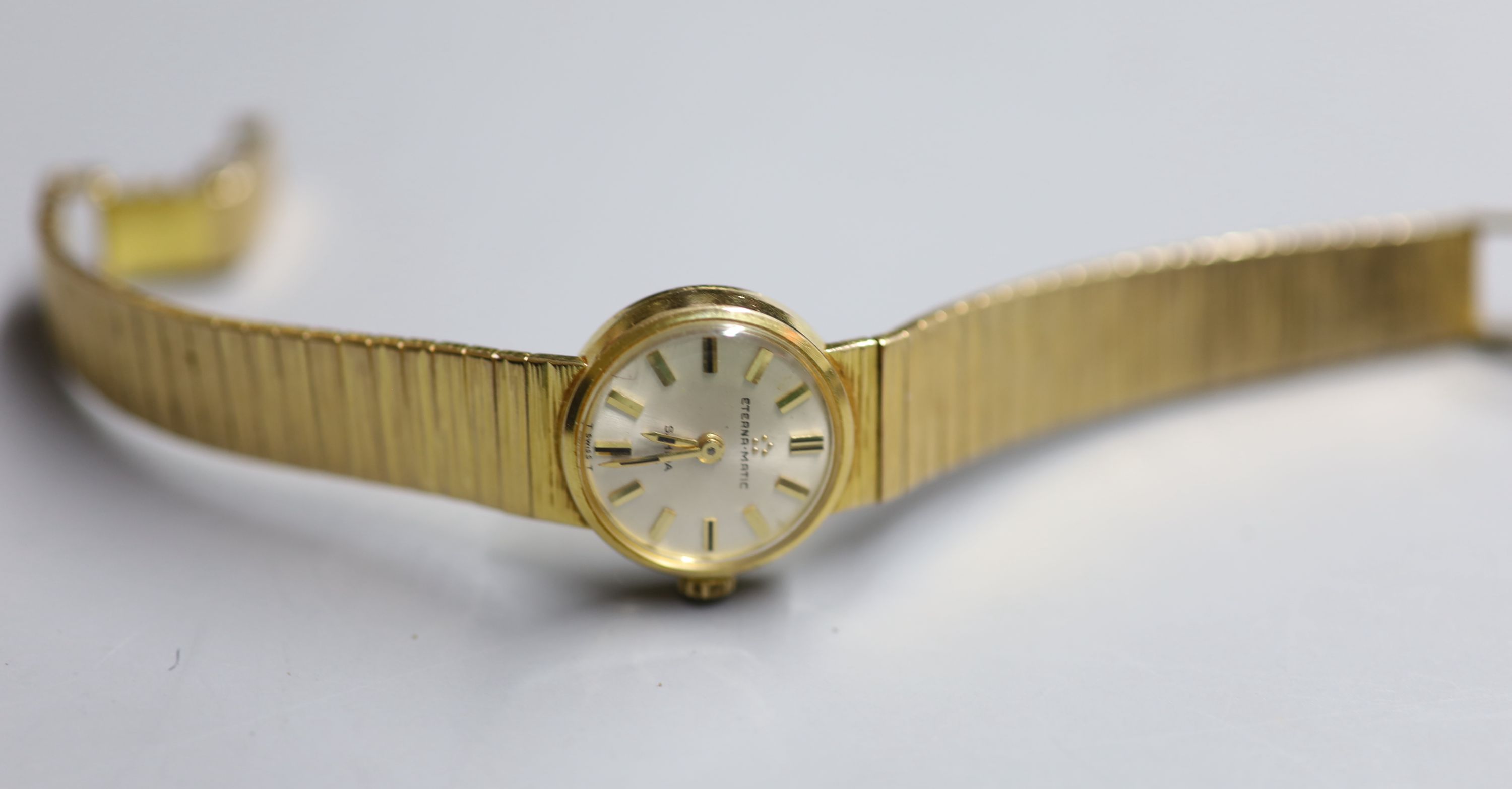 A ladys 9ct gold Eterna-Matic manual wind wrist watch, on a 9ct gold bracelet, overall 16cm, gross 30.7 grams.